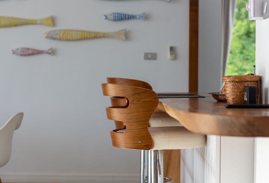 A wooden bar stool at a kitchen counter